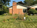 Brick house with a garden in front on a sunny day